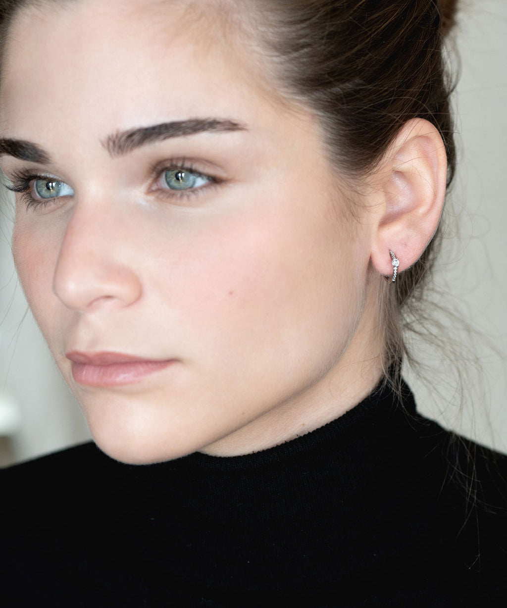 Pendientes criolla en plata de ley, disponibles con baño de rodio o en oro amarillo de 18k, con circonita blanca central.