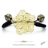 Pulsera de macramé negro con cruz de filigrana en oro 9K